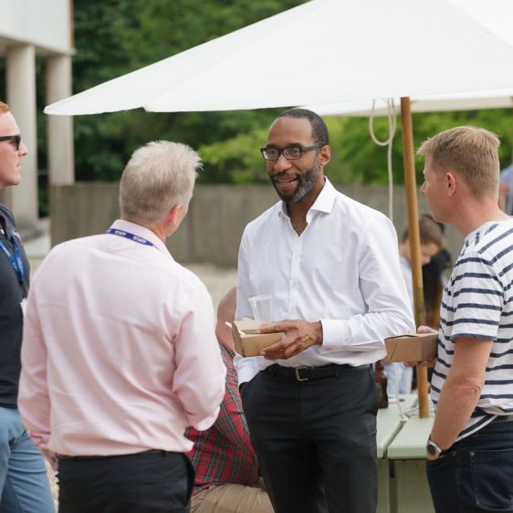 Members of the community talking at a networking event